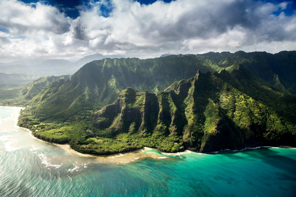 Aerial view of the green mountains of the Nā Pali Coast on Kauaʻi, Hawaiʻi
